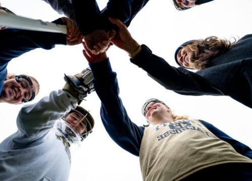 The Trinity College Women's Lacrosse Team in a huddle